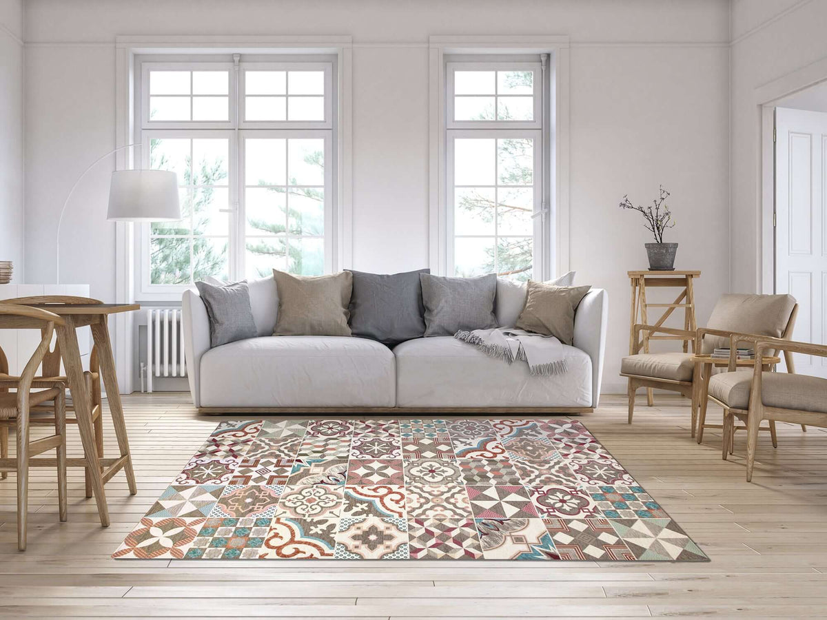 Modern geometric rug in living room with light sofa and wooden furnishings, featuring vibrant colors and patterns.