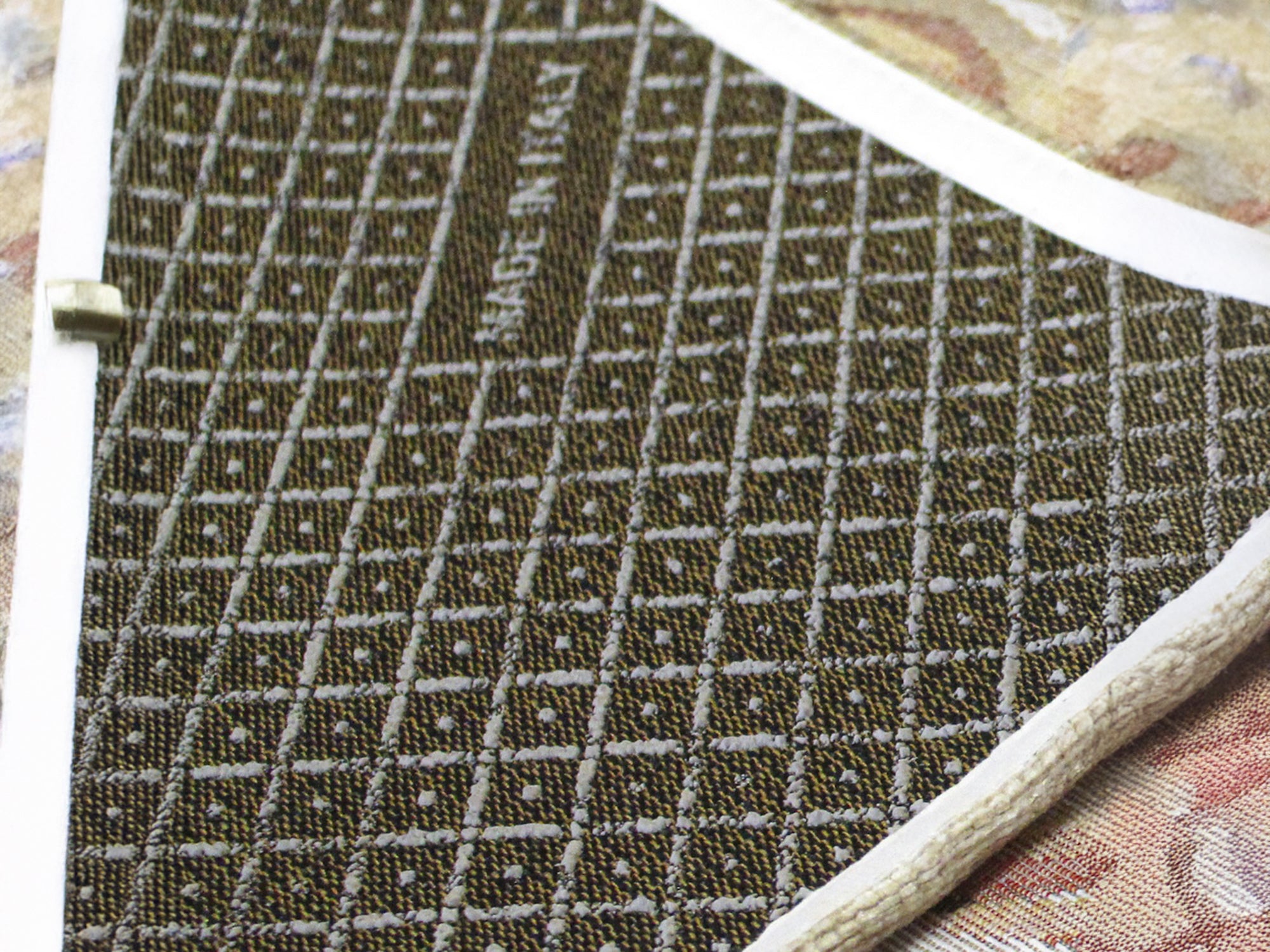 Close-up of an anti-slip rug backing with a textured pattern, showcasing its durable construction and quality craftsmanship.
