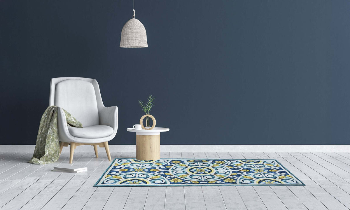 Modern kitchen rug with blue and yellow design, placed in a stylish interior with a cozy chair and table.