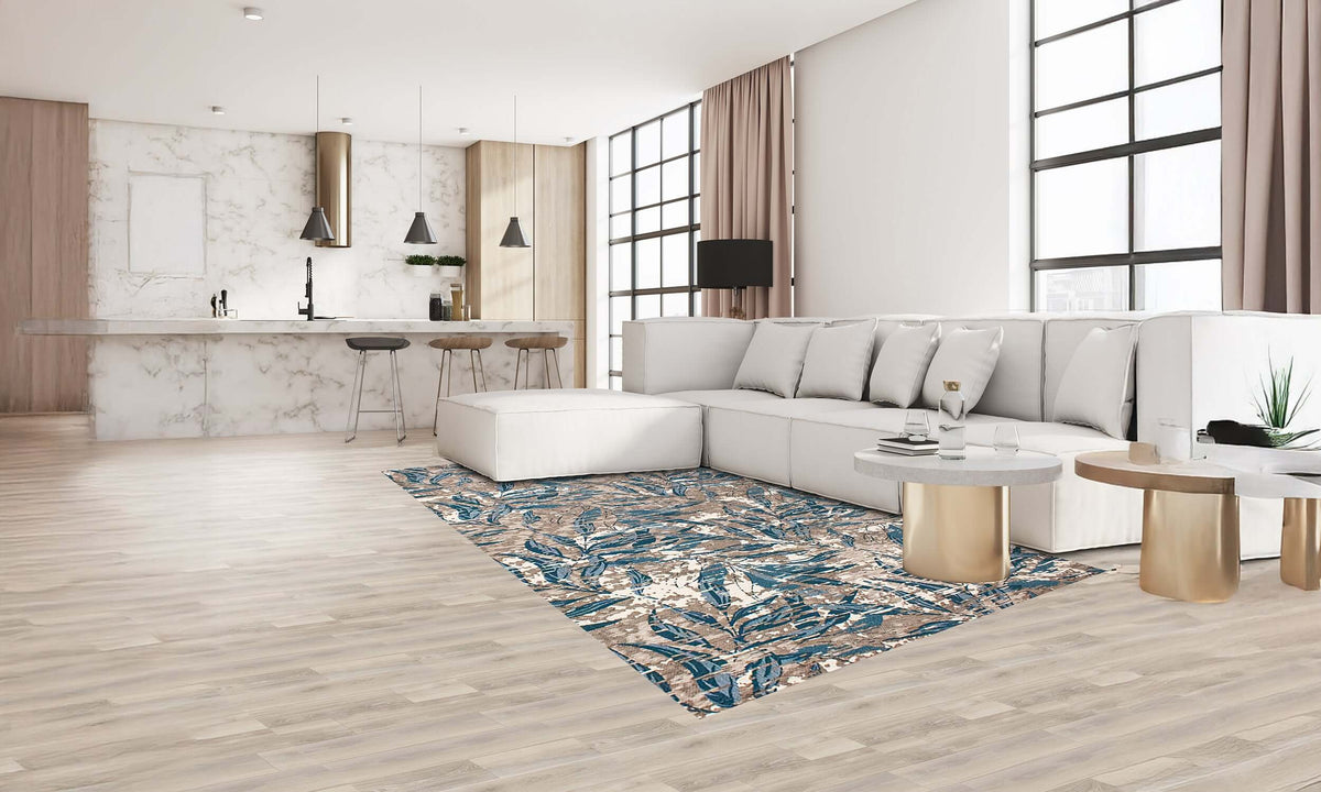 Modern foliage area rug in green and blue, enhancing a contemporary living room with light wooden floors.