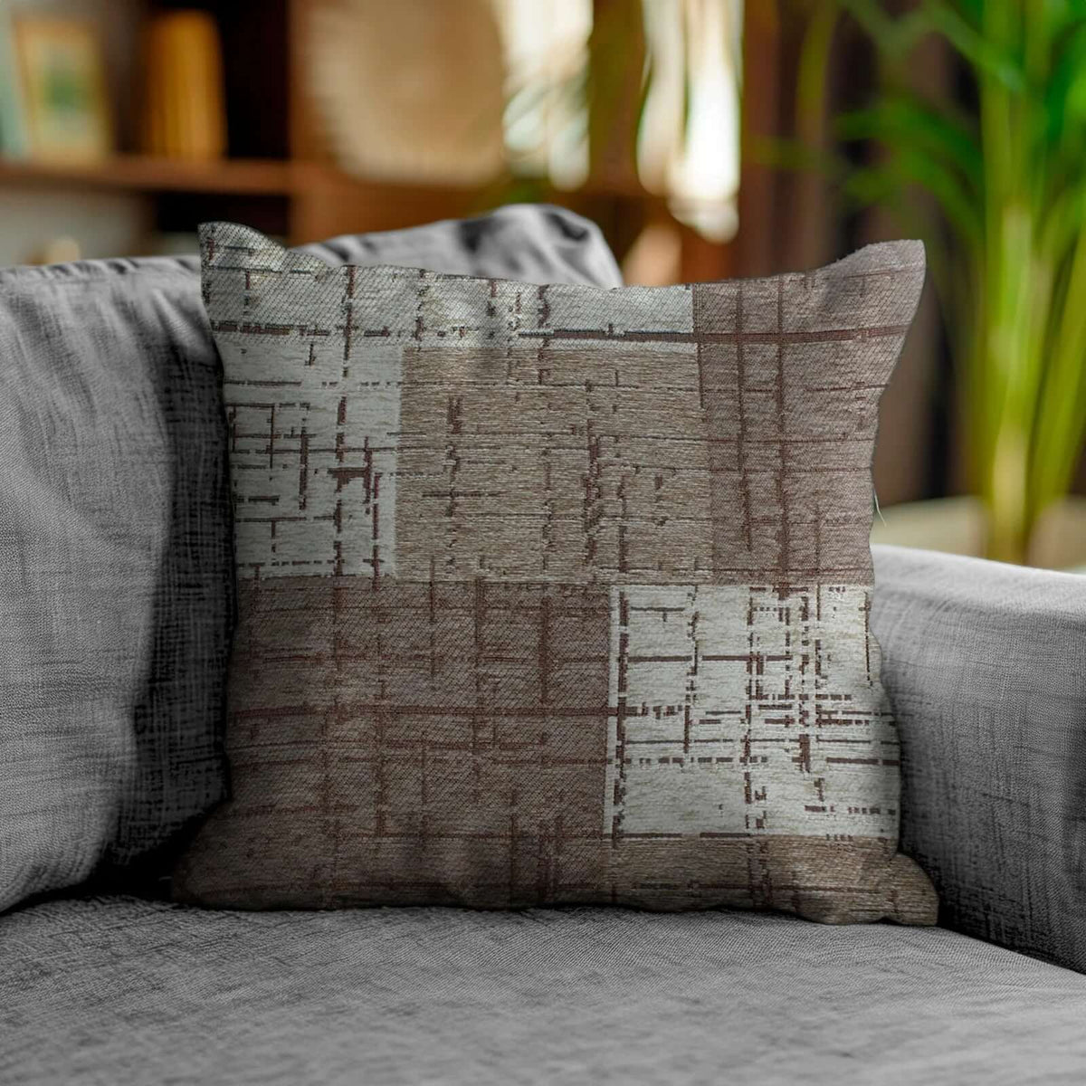 COPPIA CUSCINI ARREDO JACQUARD SFODERABILI MONDRIAN su divano, design moderno in tonalità marrone e grigio.