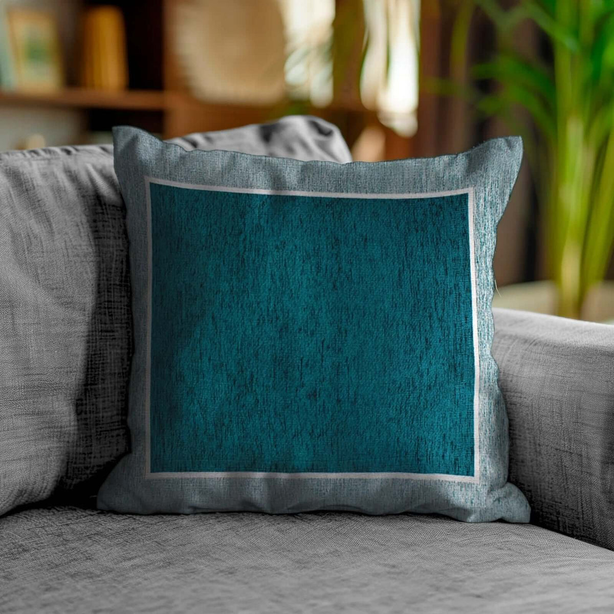 Coppia cuscini arredo jacquard sfoderabili Roma su divano moderno, colore blu teal, decorazione elegante per il living.