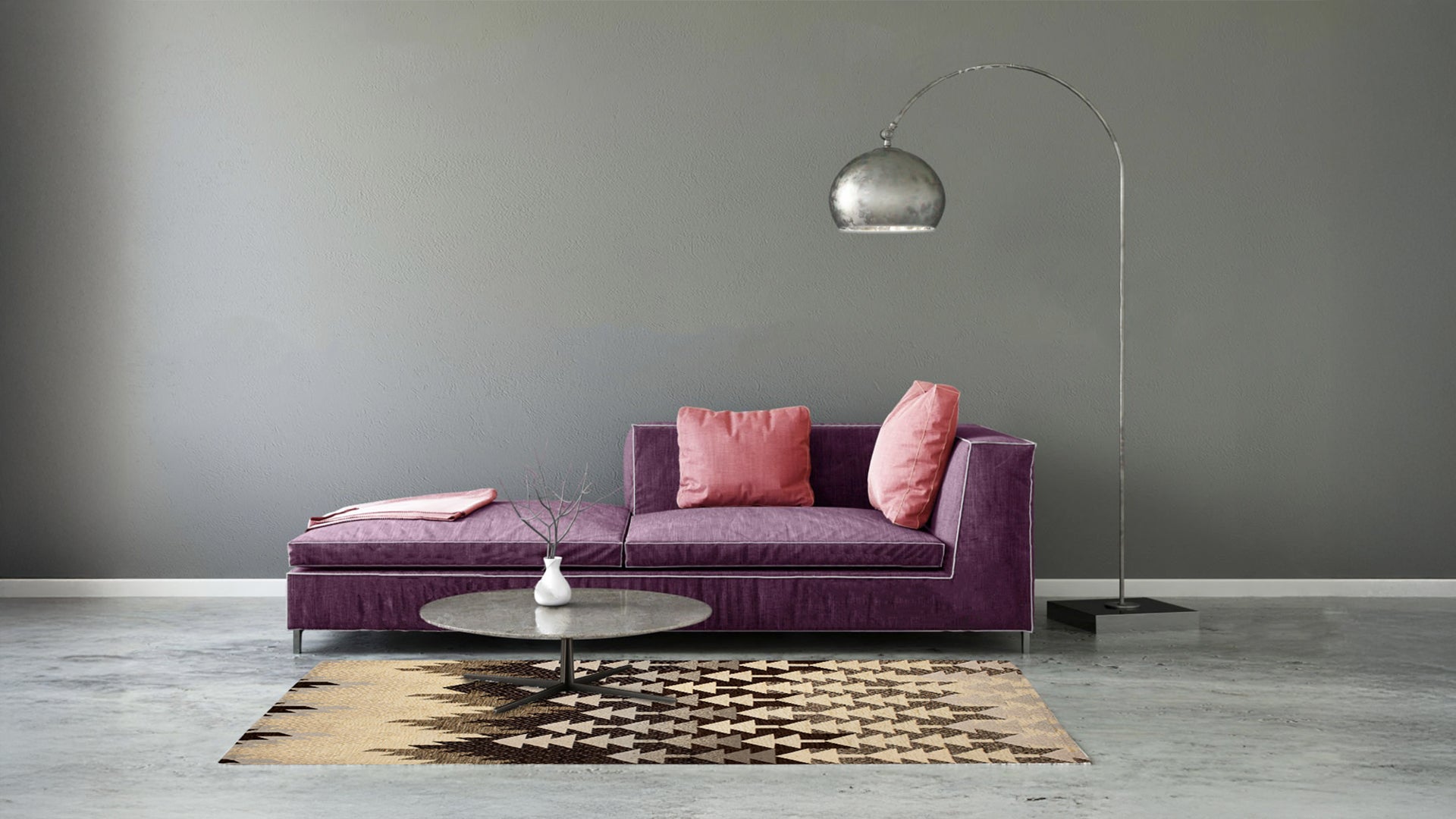 Modern living room with a plush purple sofa, pink cushions, glass coffee table, and stylish floor lamp.