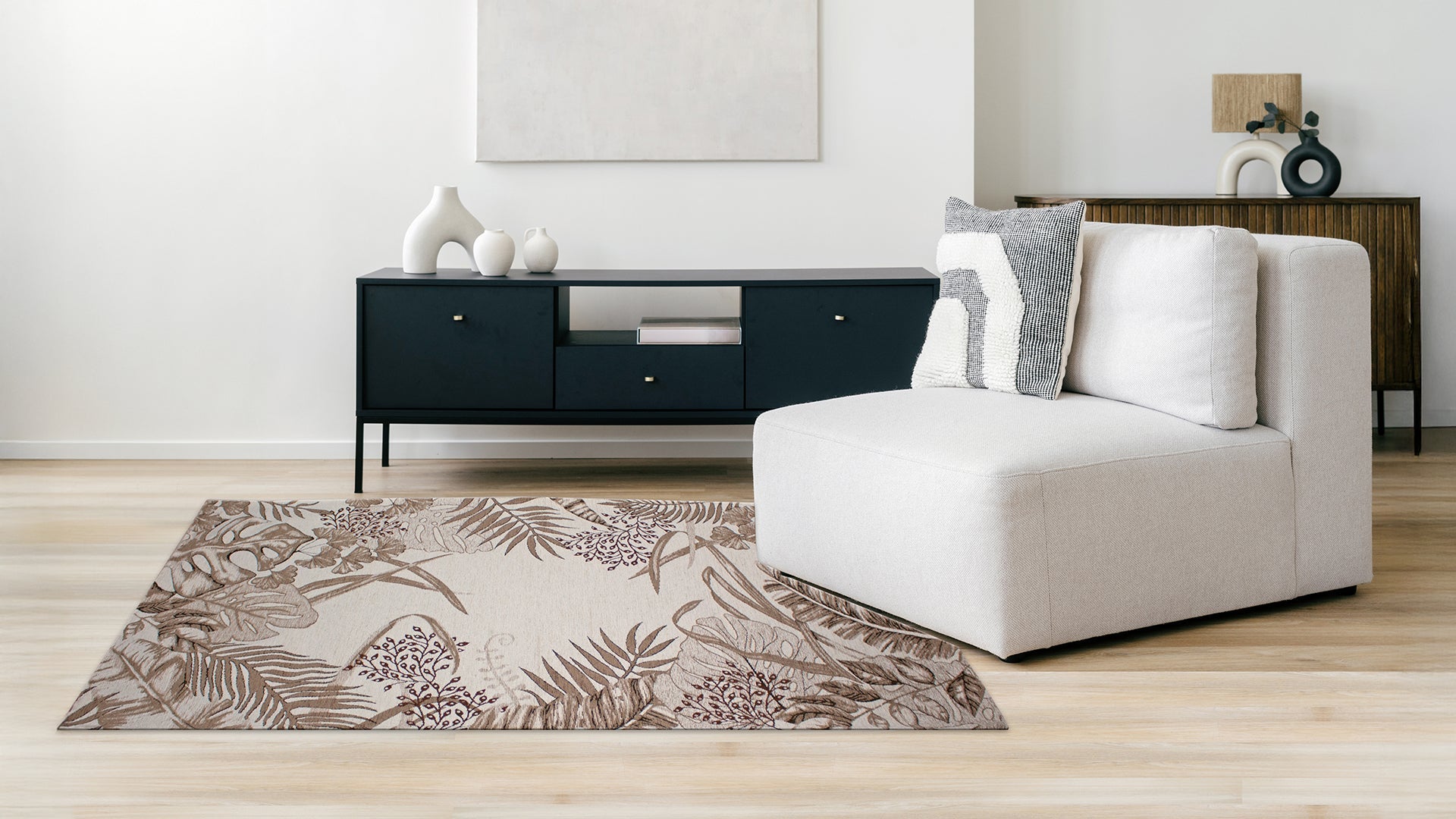 Cozy living room featuring a beige rug with tropical floral patterns, complemented by a modern sectional sofa.