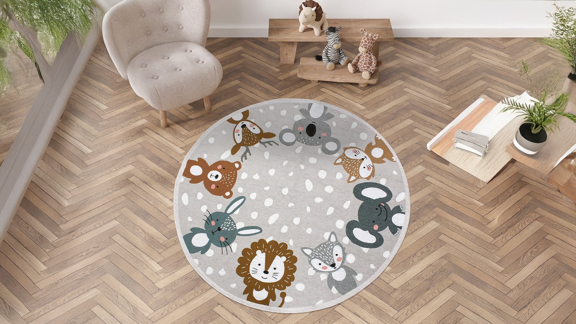 Round children's rug featuring playful animal designs in bright colors on a soft gray background.