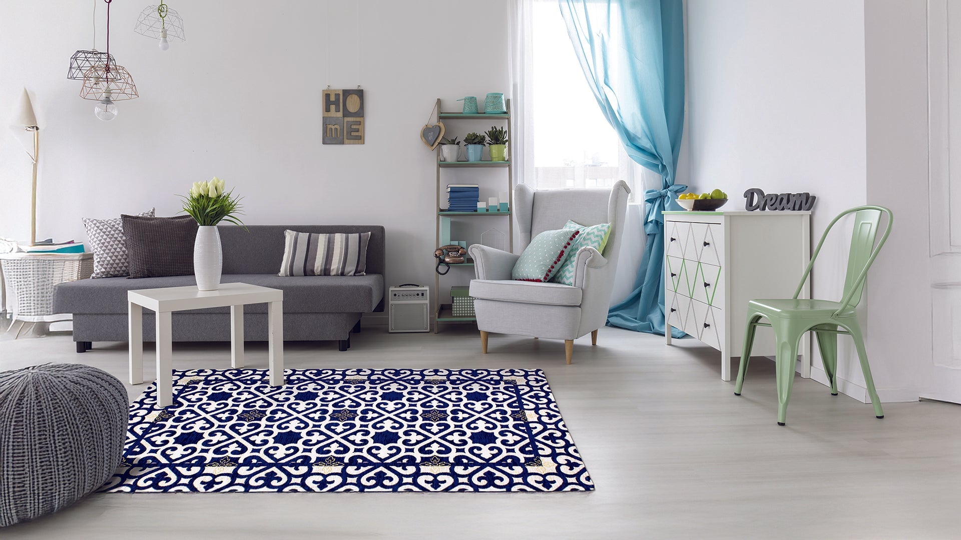 Modern living room featuring a stylish rug, grey sofa, and cozy decor elements in a bright space.