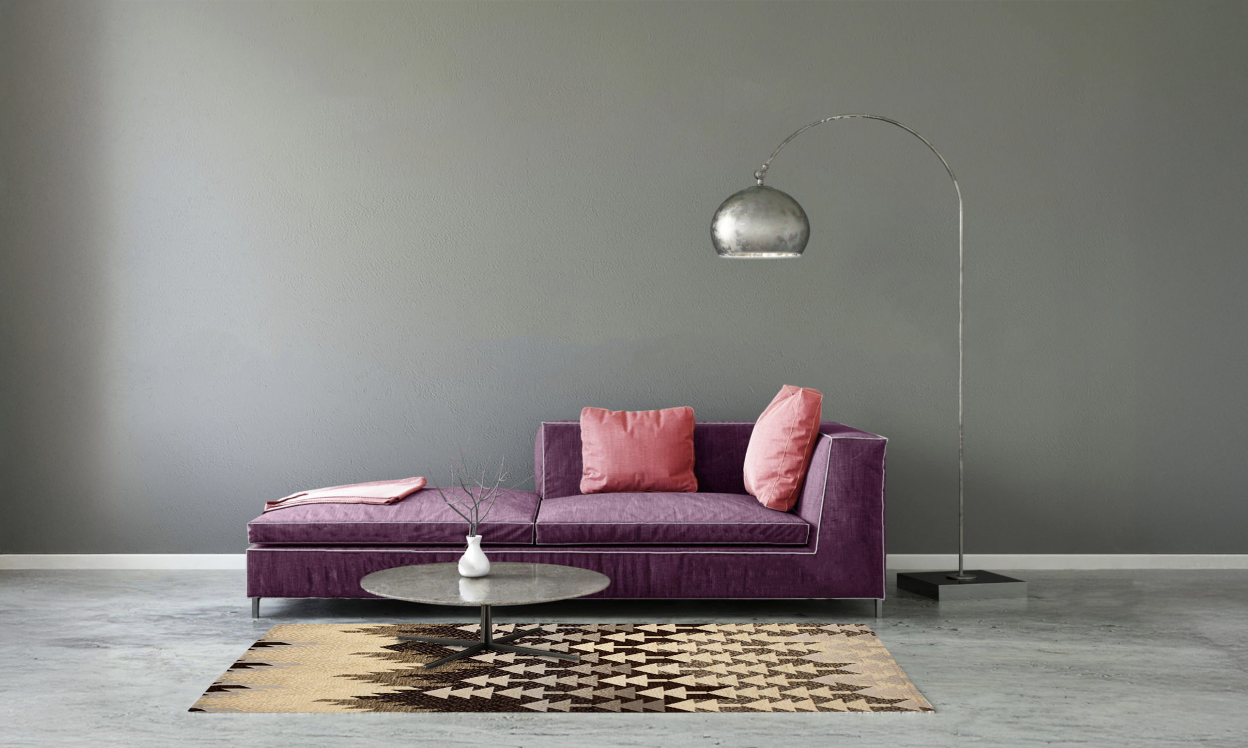 Modern living room with purple sofa and decorative rug on grey floor, featuring a sleek floor lamp.