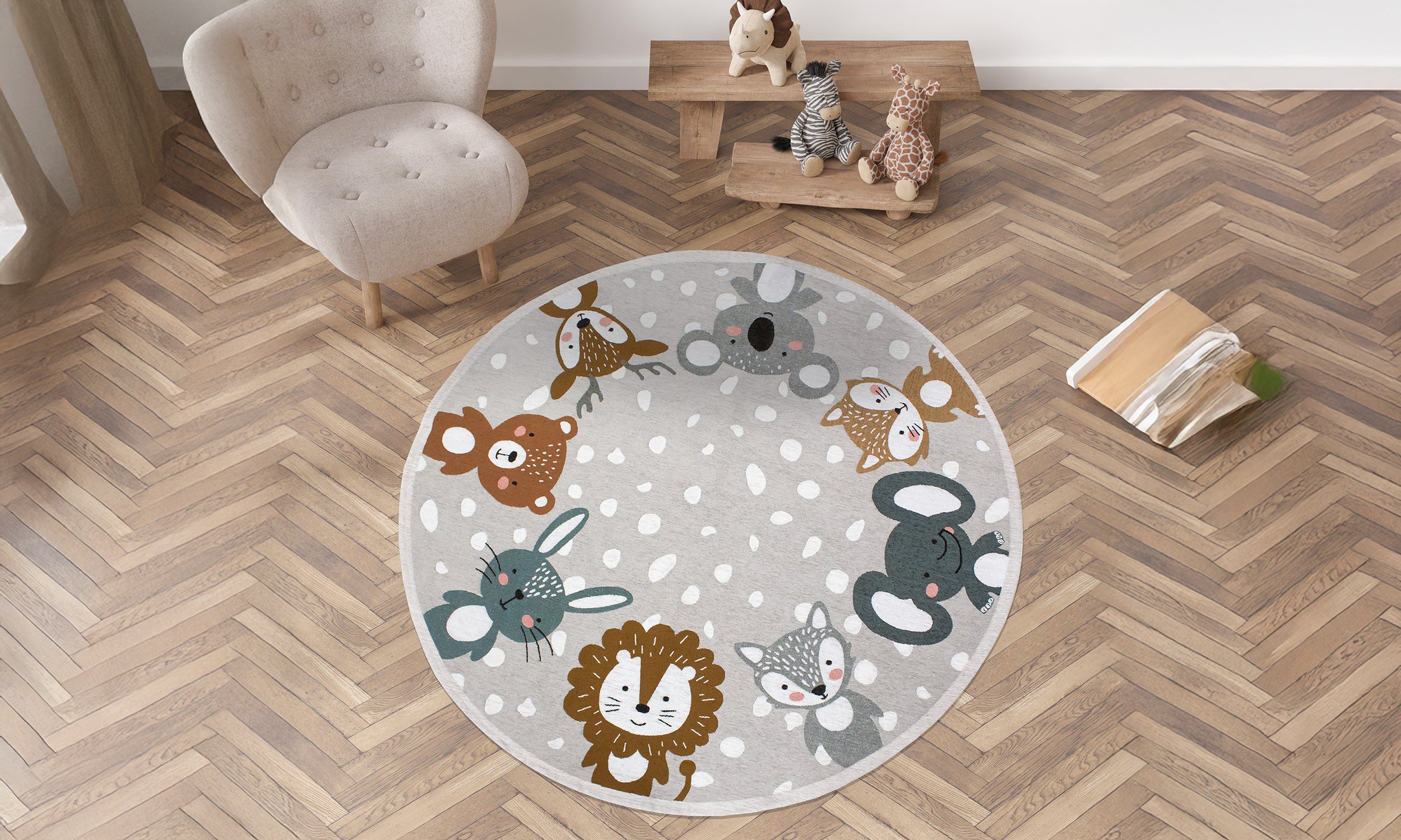 Round gray kids' rug with colorful animal designs, measuring 140 cm, anti-slip base, soft texture.