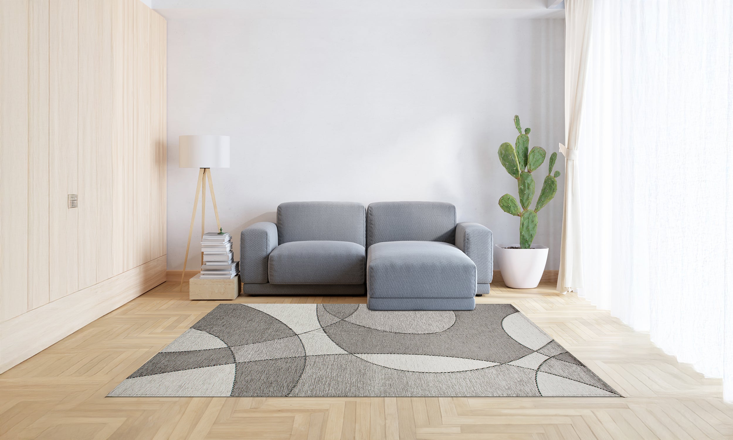 Modern gray rug with abstract design in a bright, stylish living room setting featuring a gray sofa.