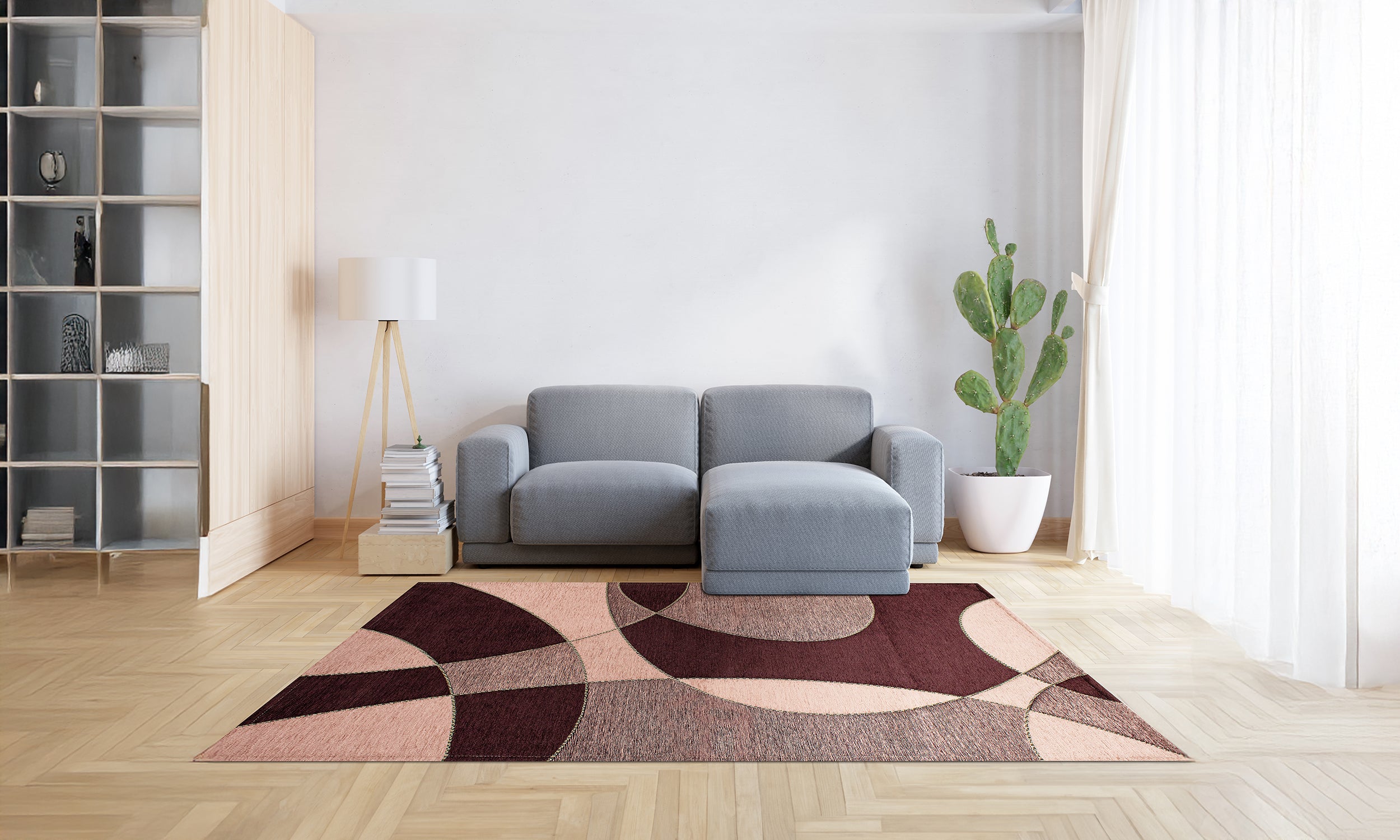 Modern wine-colored rug in living room with gray couch and plants, showcasing vibrant pattern and soft texture.