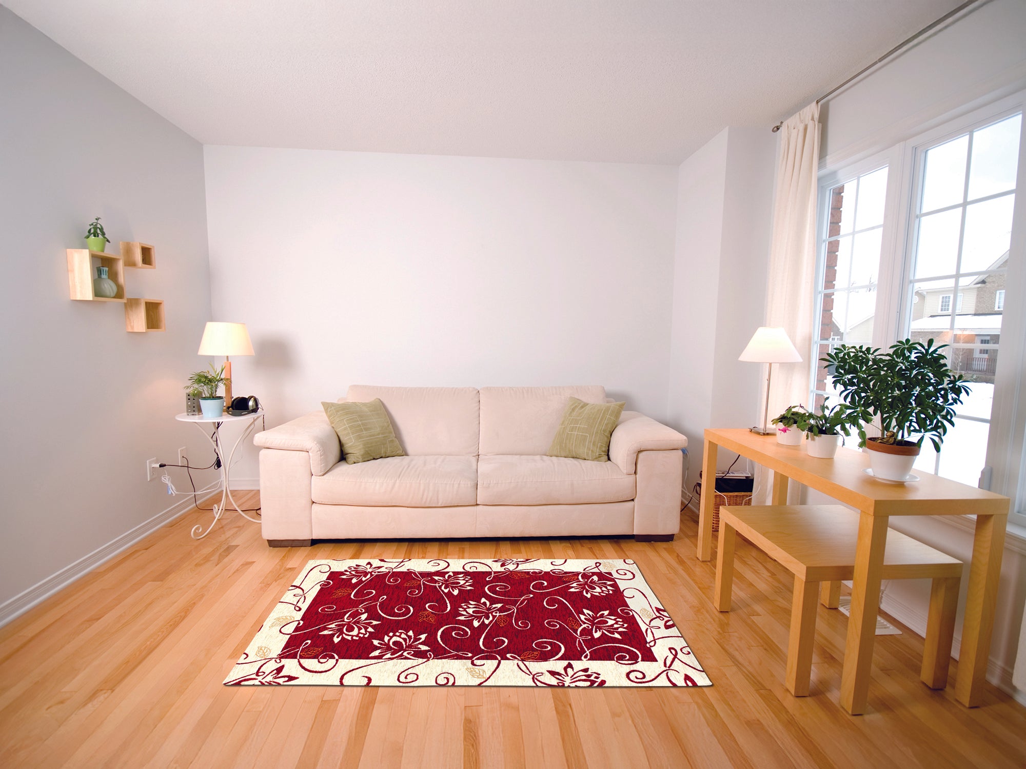 Modern living room with a red floral rug, beige sofa, green cushions, and wooden dining table.