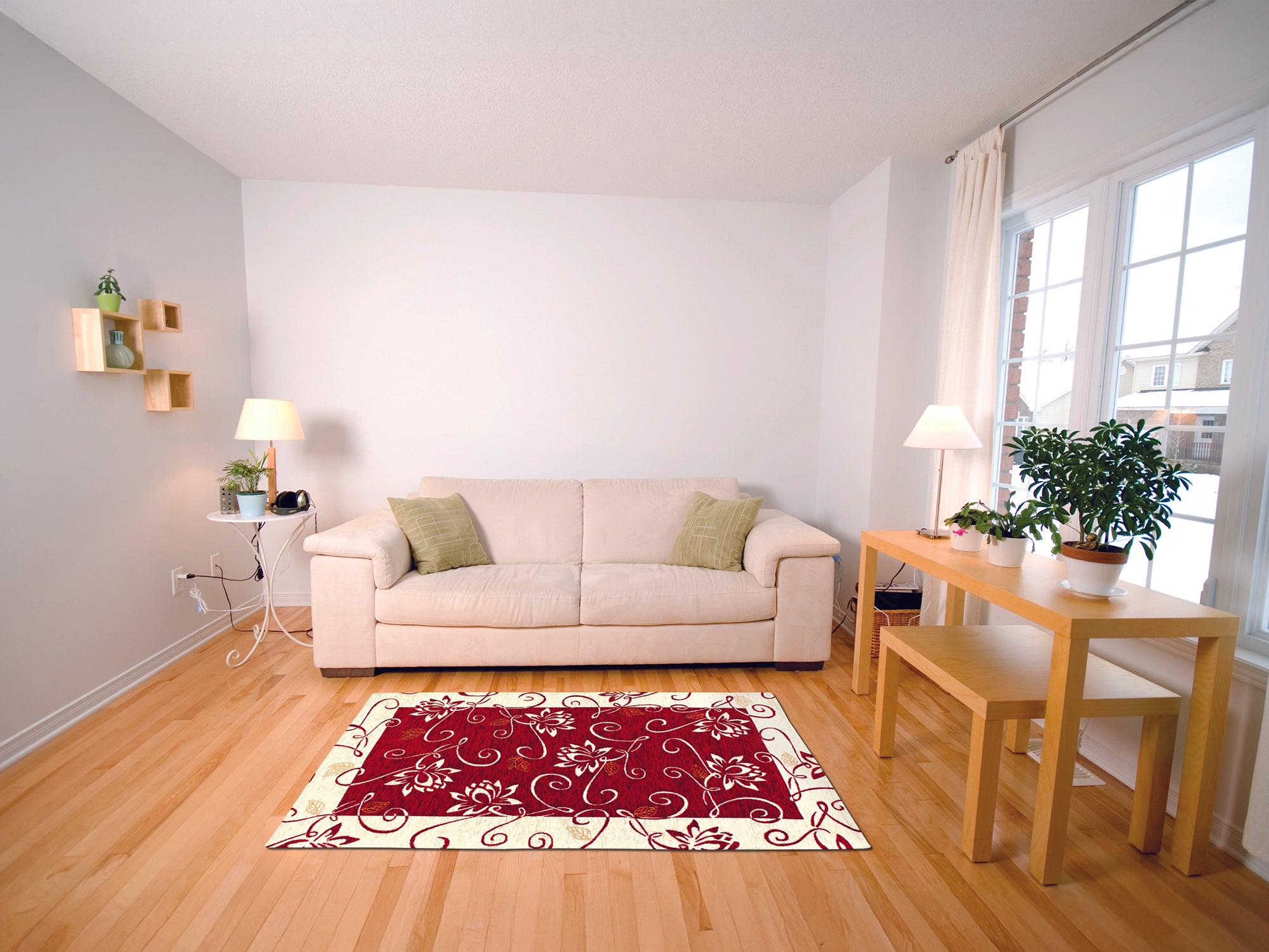 Red and cream floral area rug in a modern living room with beige sofa and wooden dining table.