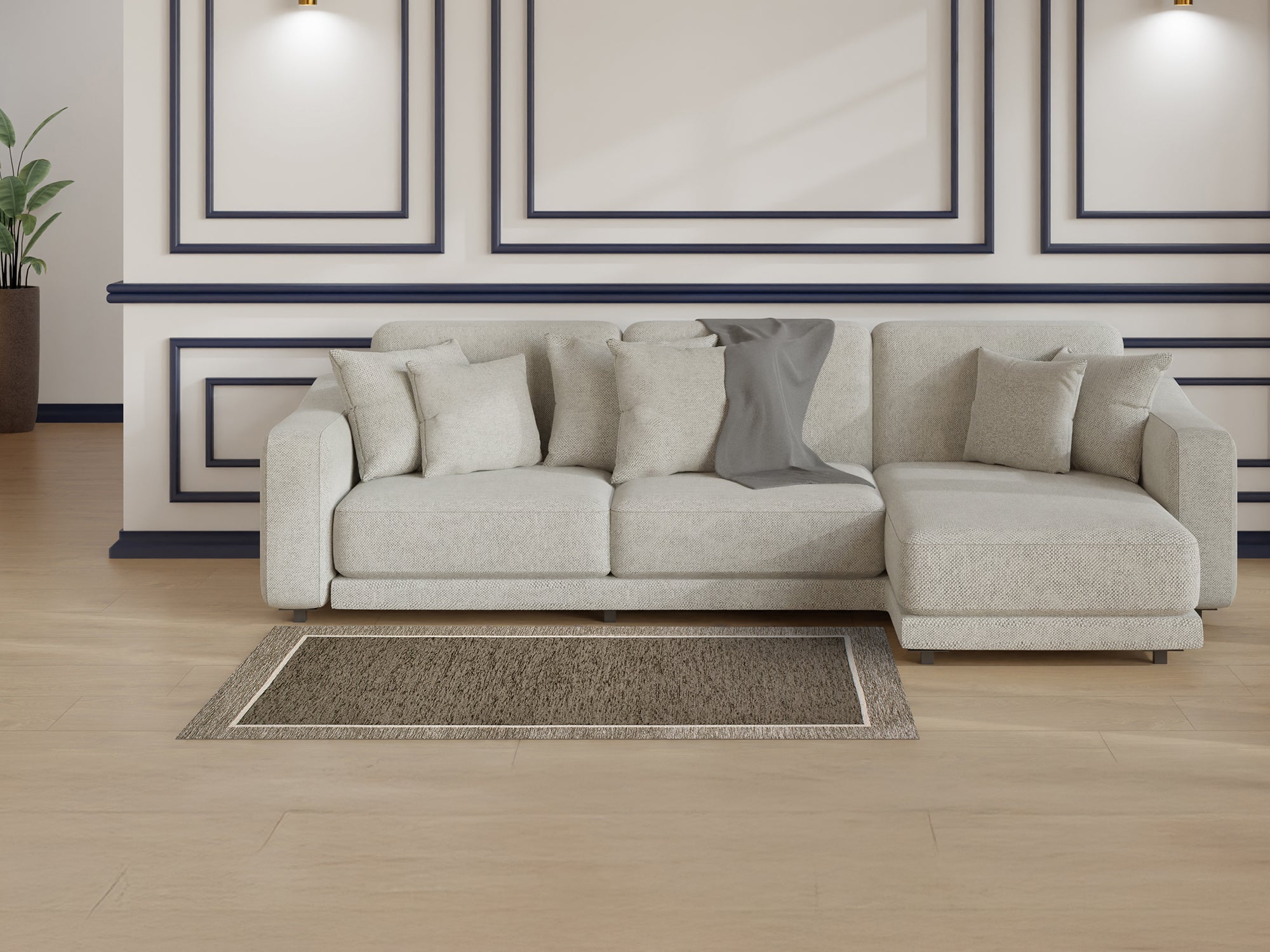 Modern living room featuring a large beige sofa with pillows and a textured rug on polished wood flooring.