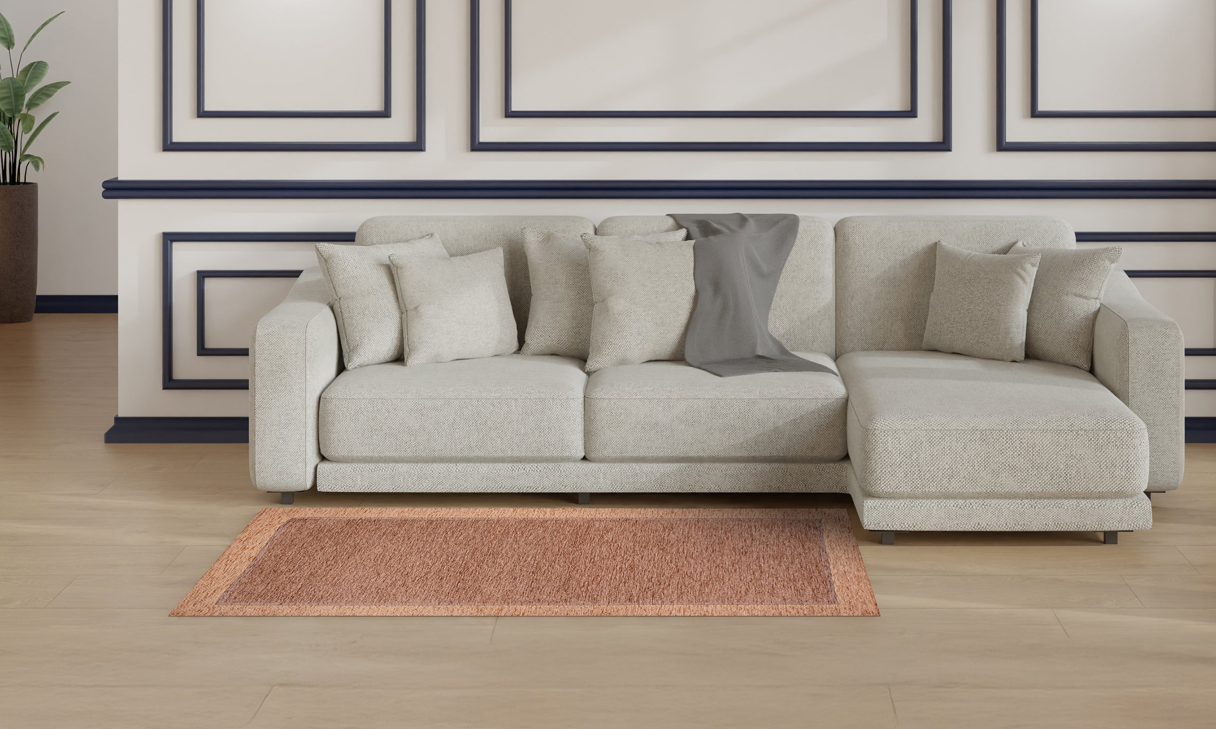 Modern living room featuring a light gray sofa and an antique pink rug, creating a cozy atmosphere.