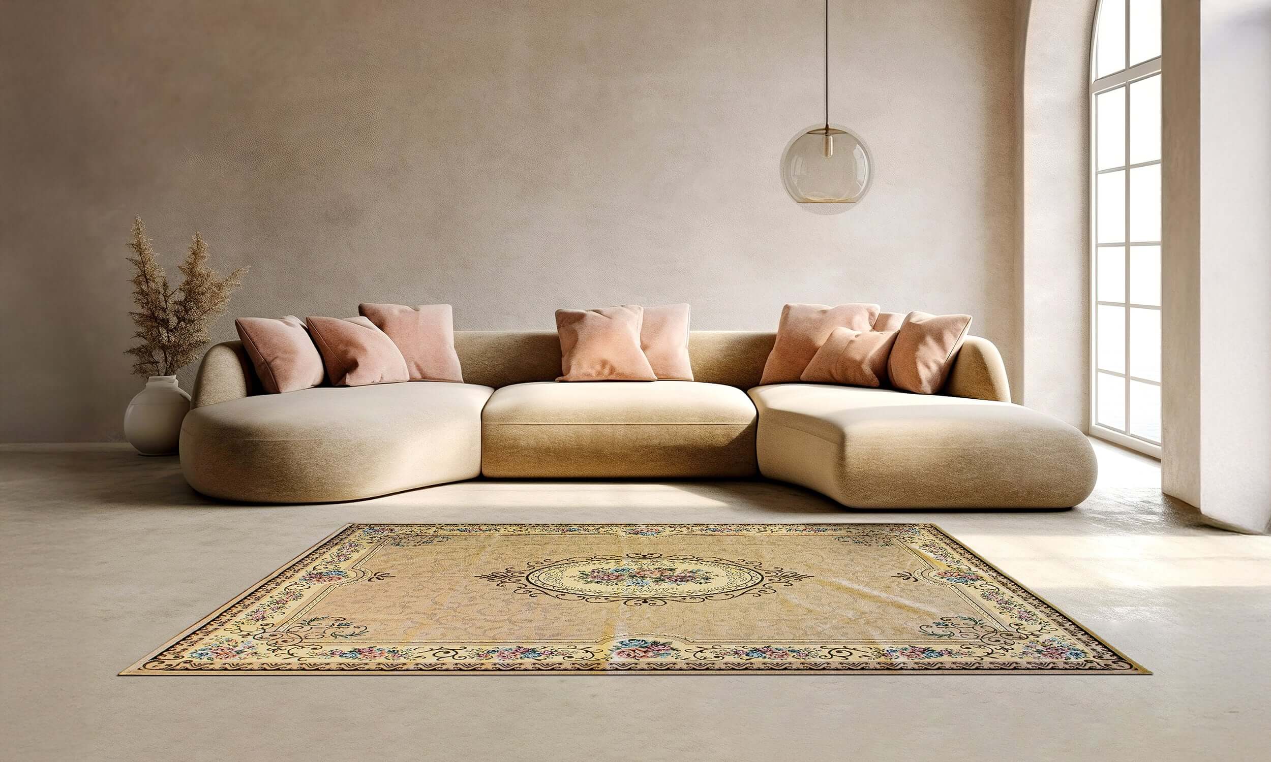 Elegant beige area rug on a modern light living room floor with a curved sofa and decorative pillows.